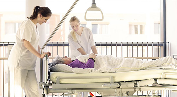 nurses pushing patient bed
